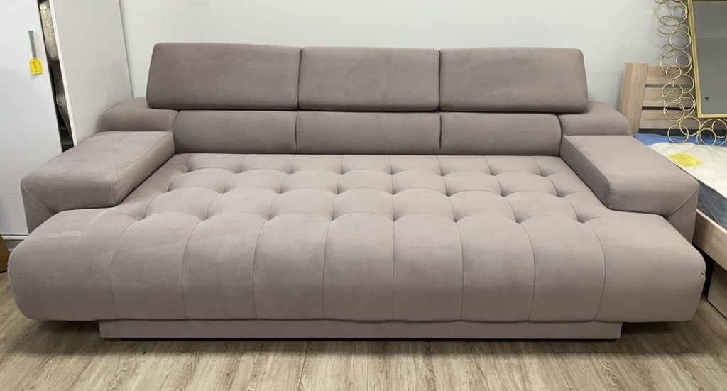 Beverly Cappuccino Sofa Bed w/Electric Pull-Out by Prestige Furnishings near a bed and a fridge in a compact room
