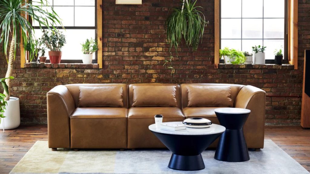 Burrow Mambo Sofa in low profile near two side tables and a plant in a farmhouse living room