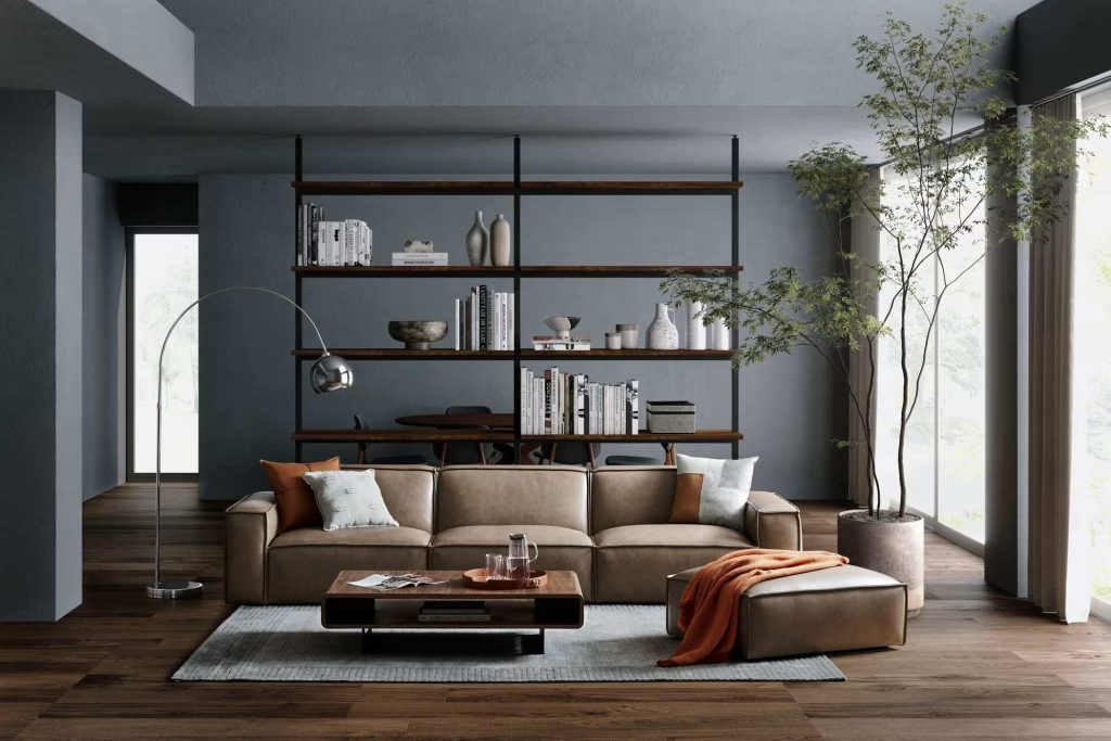 Castlery Jonathan Leather Extended Sofa in dark brown with cushions and modular chaise near a wood coffee table, a floor lamp, a plant and a shelf with books and decorations in a mid century modern living room