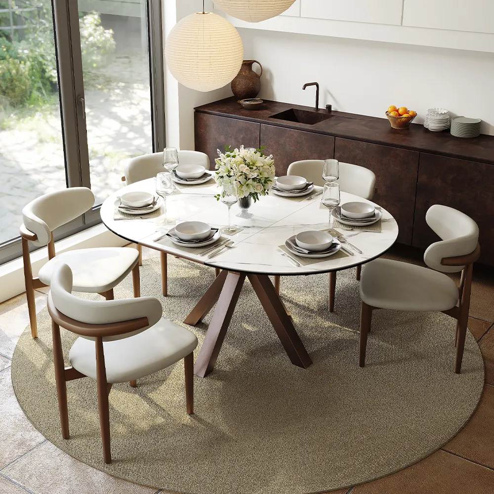 a round marble dining table with 4 dining chairs in a compact dining room