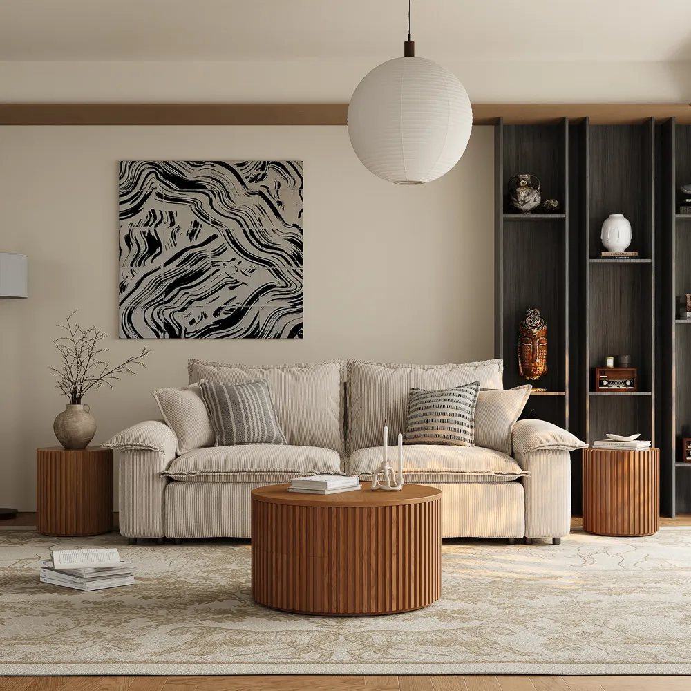 a well decorated living room with a beige sofa, two round wood side tables, a round coffee table and a black shelf for decorations