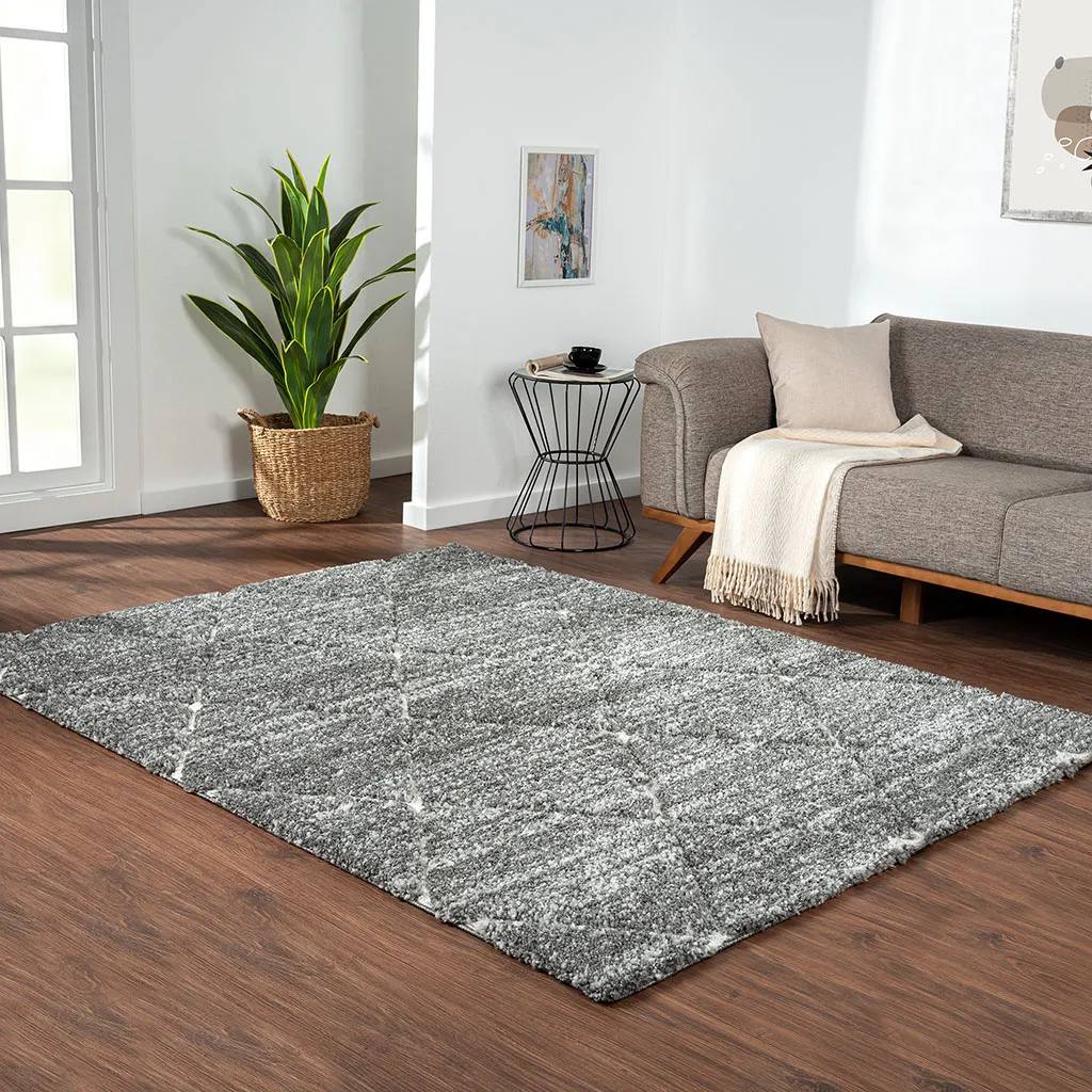 8' x 10' Modern Minimalist Diamond Shaped Rug near a sofa, a side table and a plant in a mid century modern living room