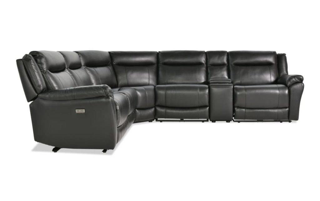 Black leather power reclining sectional sofa with multiple seats, built-in console storage, cup holders, and extended footrests.