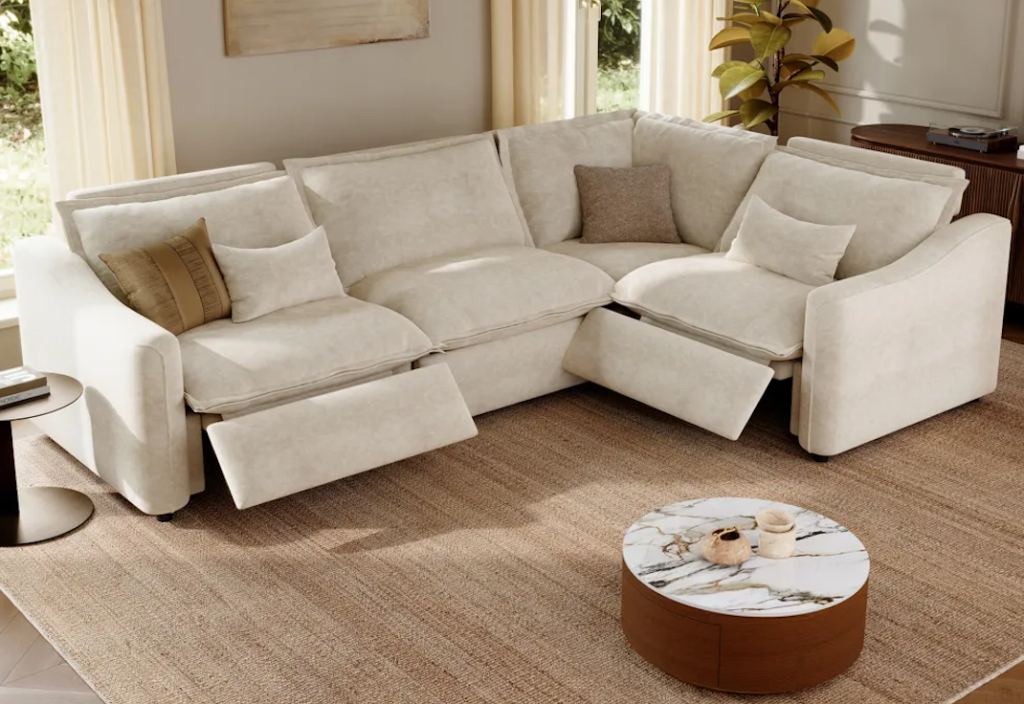 Cozy cream boucle power reclining sectionals with dual recliners and a modern travertine coffee table.