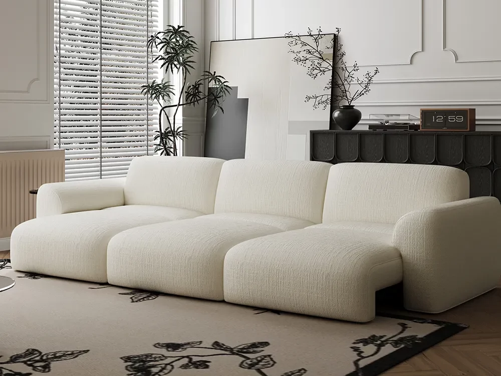 povison 3-seater Aurora Power Sofa Bed near a plant, a painting and a console table with a plant, a media and a clock on top in a living room
