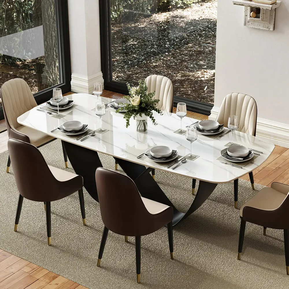 Rectangular white dining table centered on a large neutral rug, with visible chair clearance around all four sides.