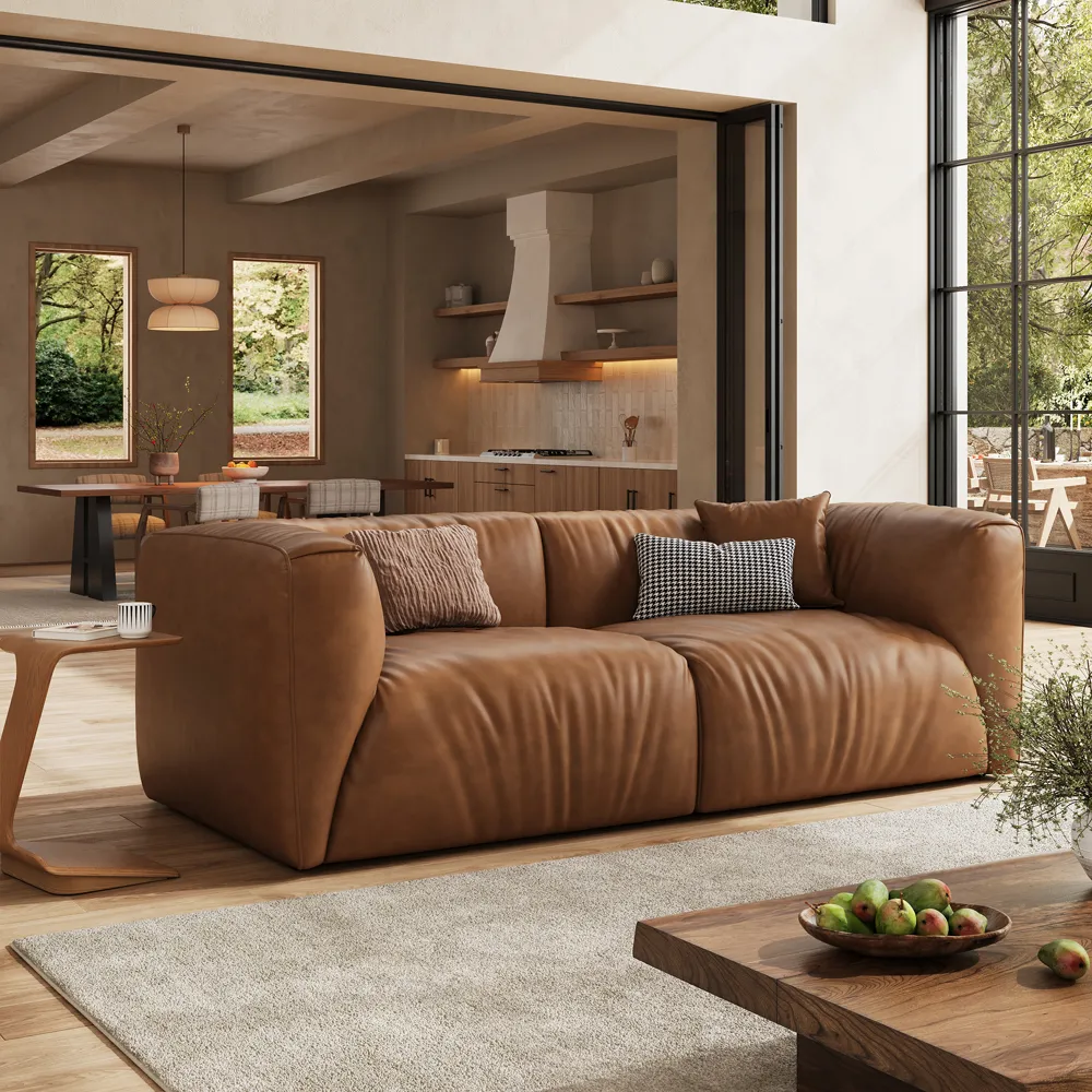 Brown performance leather sofa in a modern living room, showing smooth upholstery, warm color, and an easy-to-maintain seating surface.