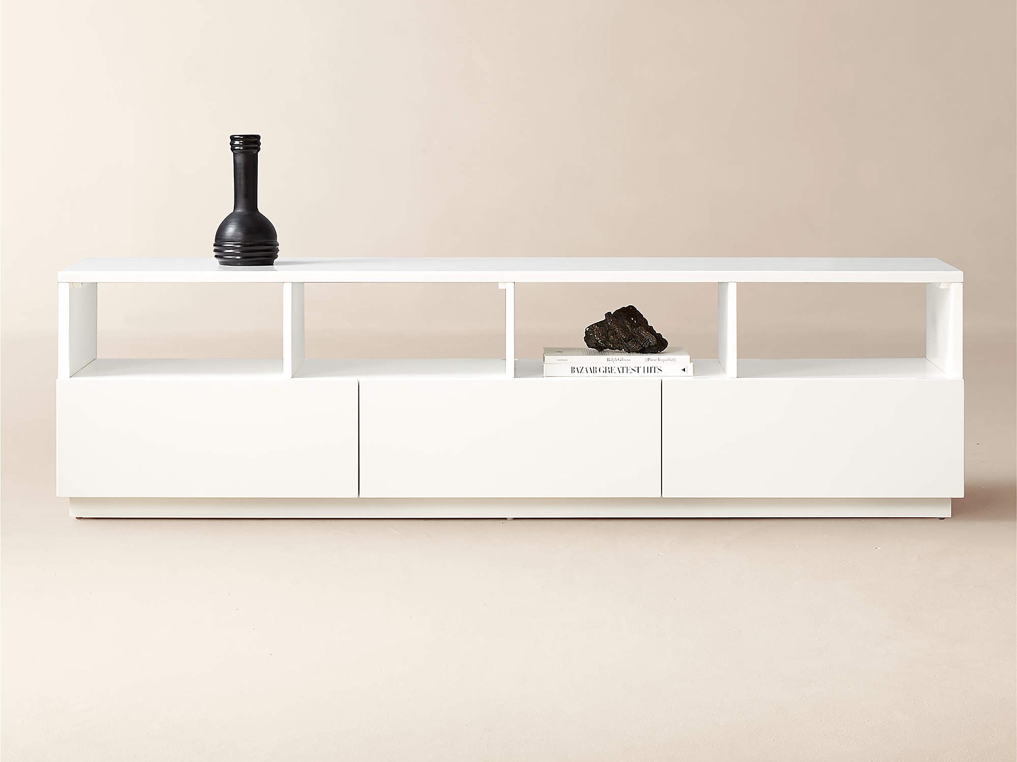 CB2 Chill 80" White High-Gloss Media Console with decorations and books for minimalist living room style