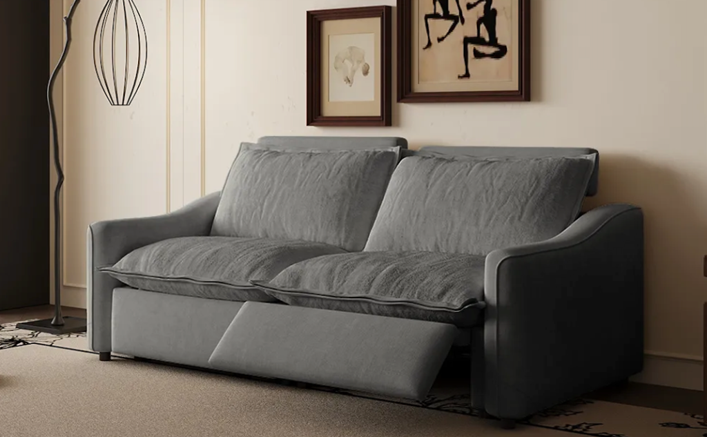Modern charcoal grey velvet power reclining loveseat placed against a cream wall with abstract framed art.