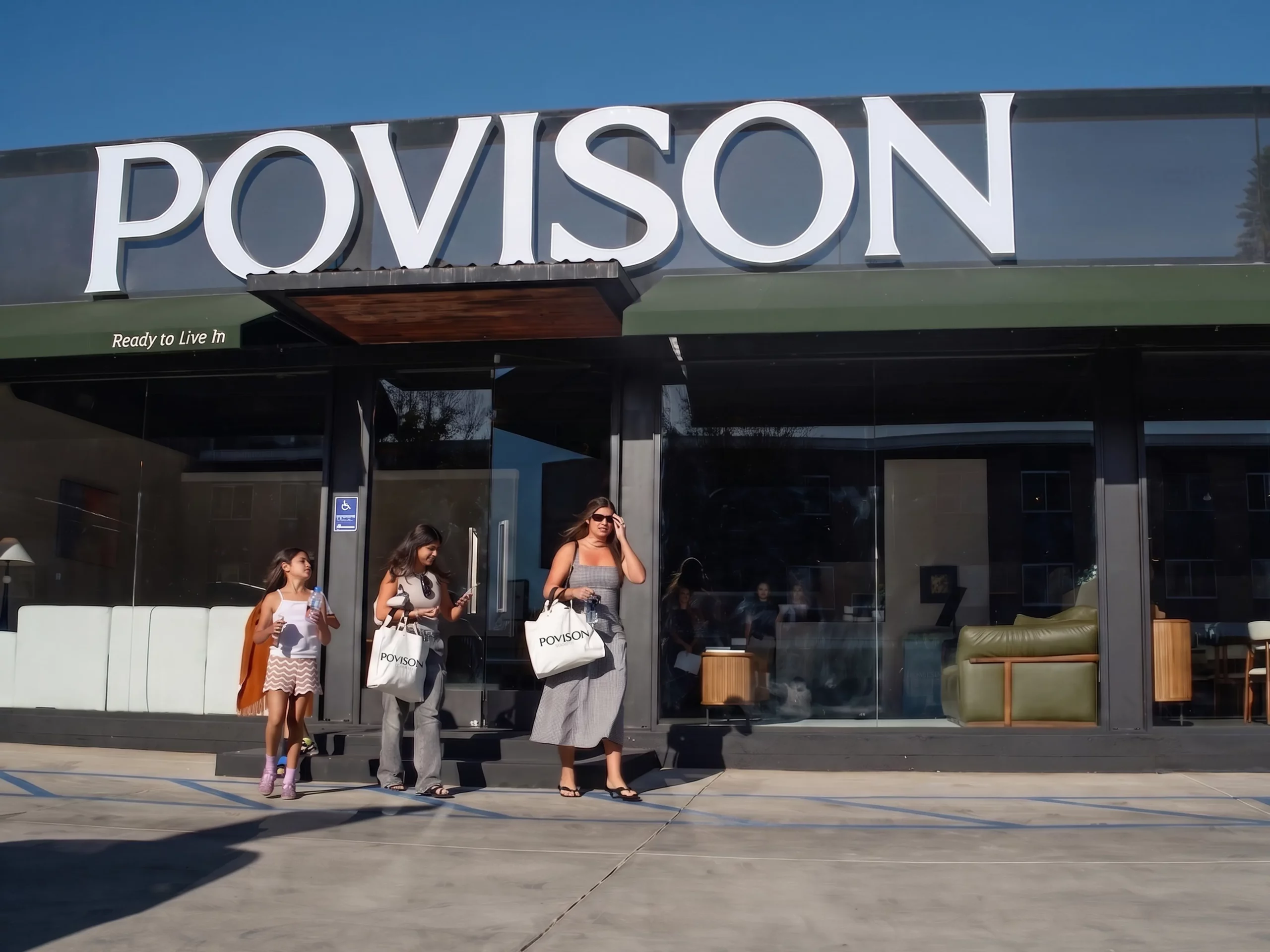 Customers walking at the front door of Povison's LA flagship store