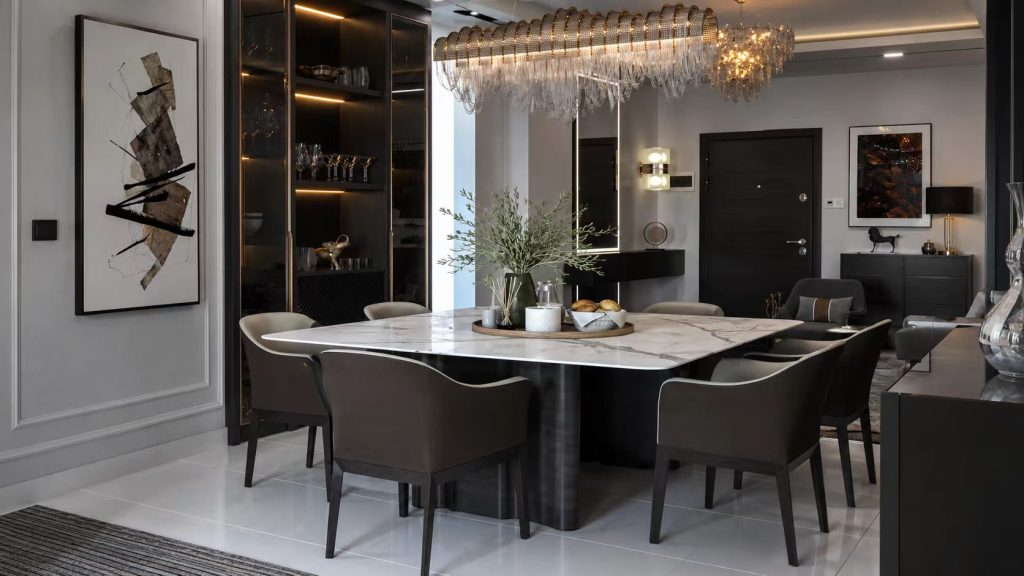 Elegant sintered stone dining table with dramatic marble veining, surrounded by dark premium leather armchairs.