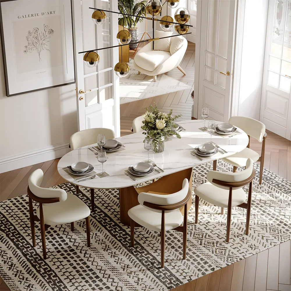 Oval white dining table with upholstered chairs on a large patterned rug, defining an open dining area with clear walking space.