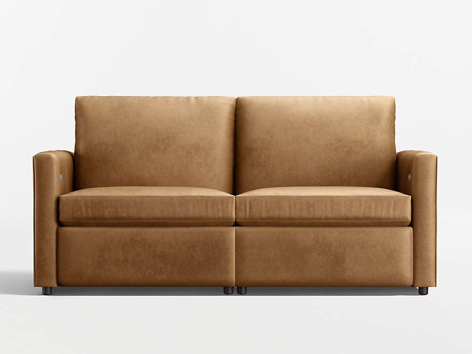 Tan leather dual power reclining loveseat with two cushioned seats, slim arms, and discreet side controls on a white studio background.