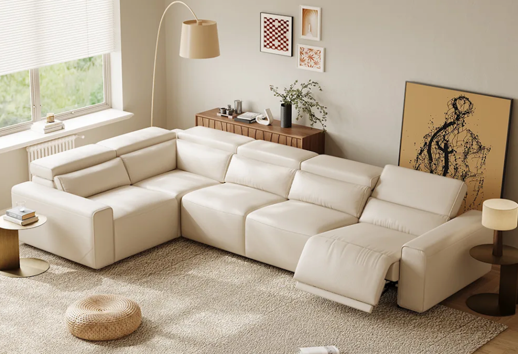 L-shaped beige fabric power reclining sectionals with multiple open leg rests on a warm jute rug.