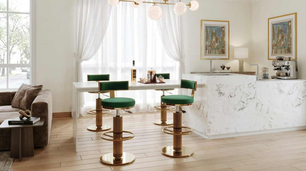 Premium green velvet bar stools with golden pedestals arranged along a white marble kitchen island.