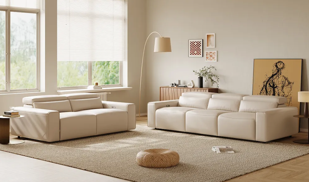 Sleek beige leather recliner sofa sets arranged on a soft textured area rug under gentle indoor lighting.