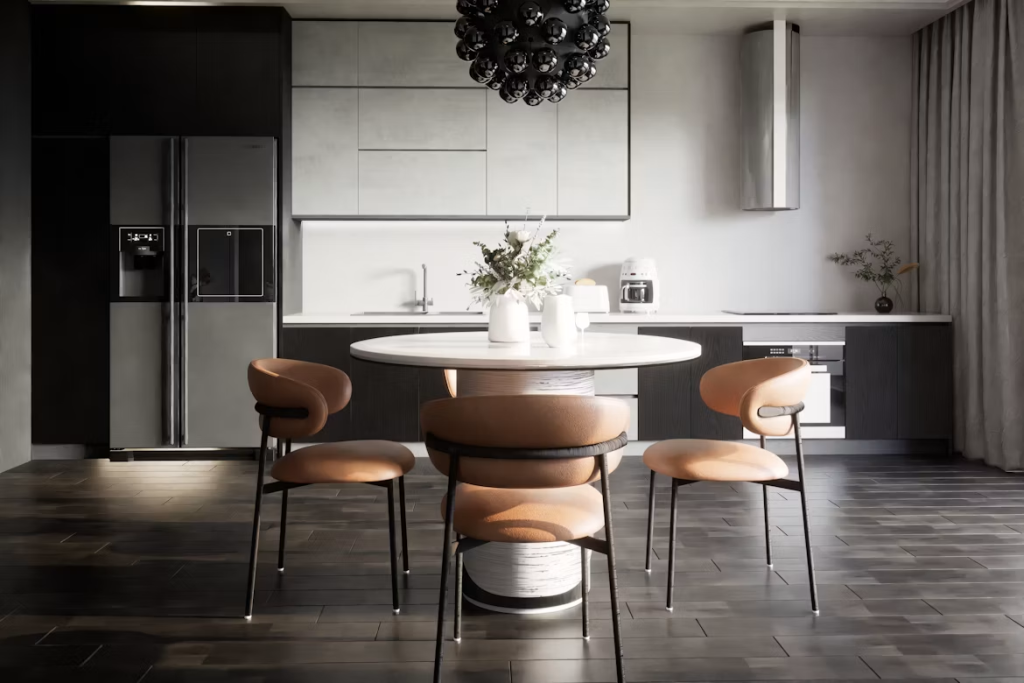 Modern round sintered stone dining table with a cylindrical pedestal base and chic tan leather chairs in a sleek kitchen.