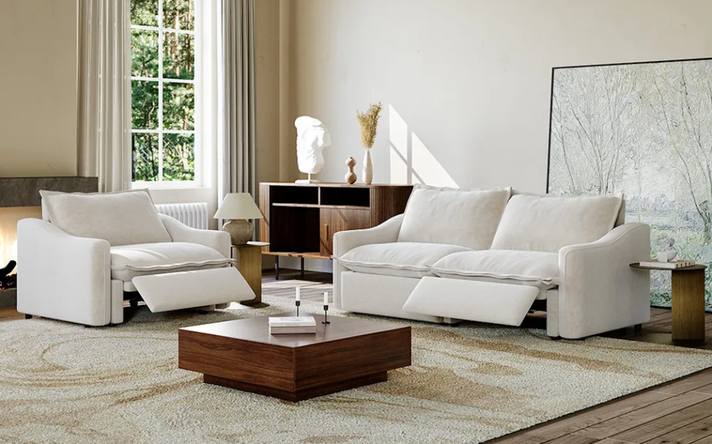 Comfortable off-white recliner sofa sets featuring extended footrests next to a mid-century wooden table.