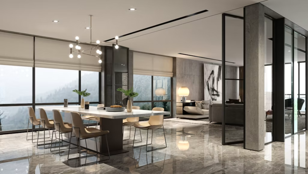 Large white sintered stone dining table paired with tan leather chairs in a luxury villa featuring a mountain view.