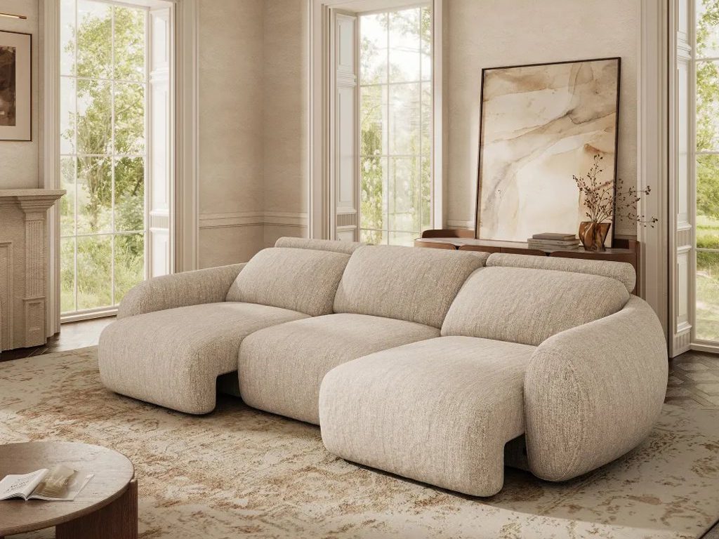 povison Mila power sofa bed with motorized functions near a round wood coffee table and a console table with a plant, a painting and some books on top in a large living room