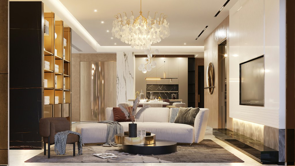 Modern open-plan living room with a curved sofa, round coffee table, vertical shelving, paneled TV wall, and layered warm lighting.