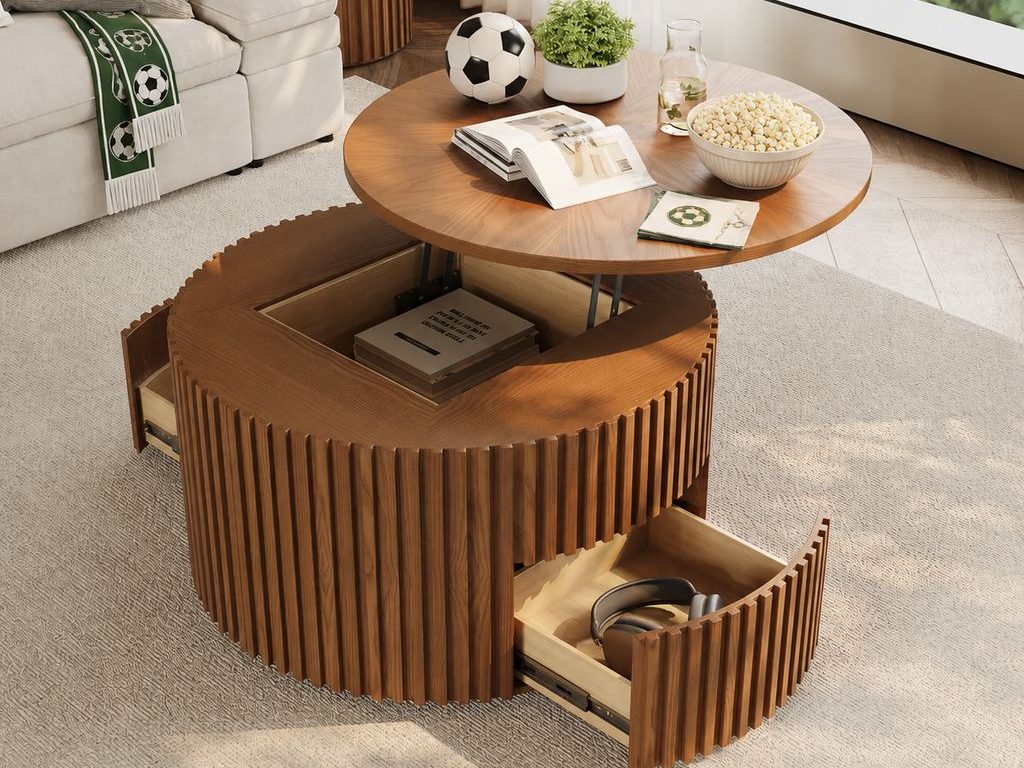 Round wood lift-top coffee table with open drawers, popcorn, a soccer ball, and a green soccer scarf in a bright living room prepared for a World Cup watch party.