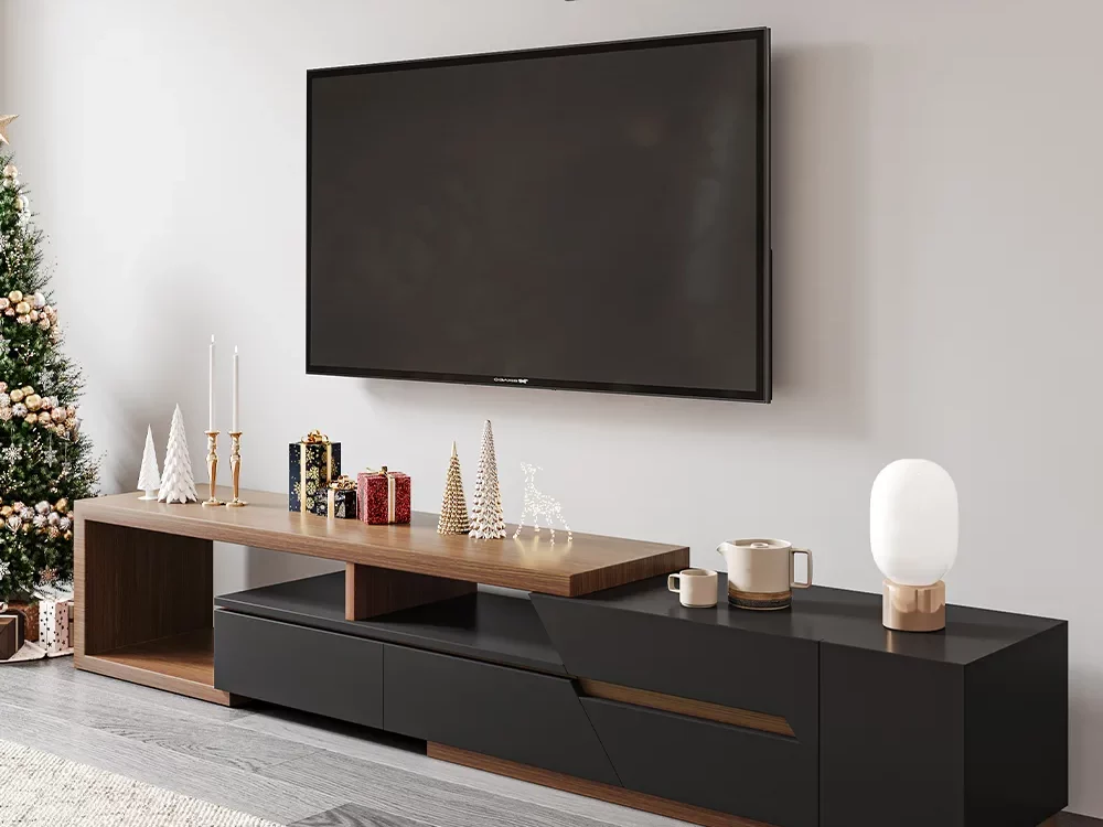 Minimalist Expandable Pinewood TV Stand with candles, lamps and decorations on top near a Christmas tree