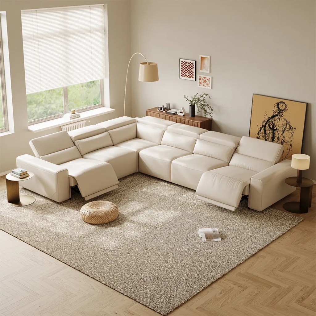 White U-shaped power reclining sectional with multiple adjustable headrests and extended footrests in a bright modern family room with a large textured rug and window blinds.