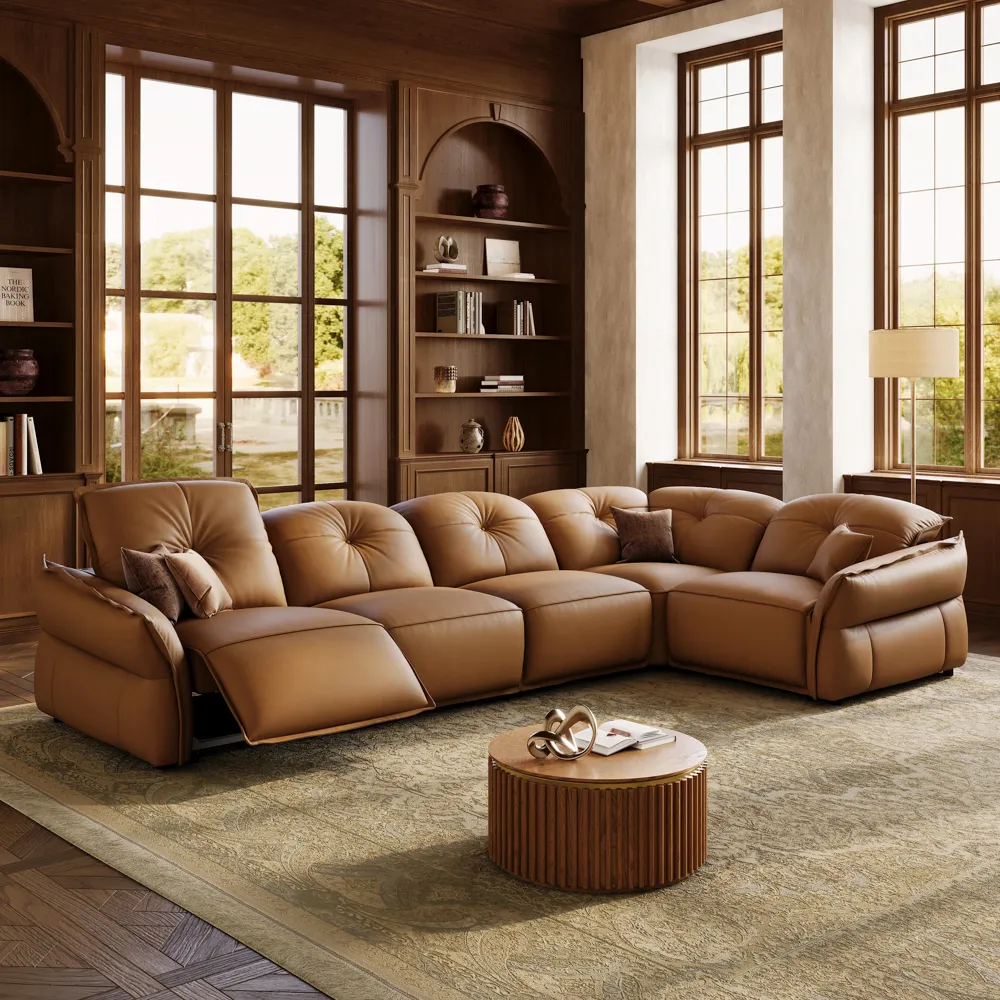 Brown leather reclining sectional sofa with an extended footrest in a traditional family room with dark wood built-ins, tall windows, and a round wood coffee table.