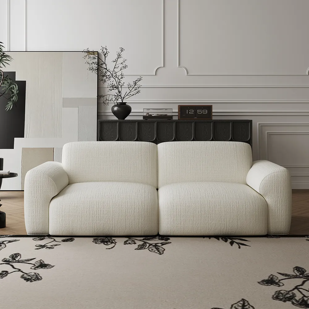 Cream sofa bed in a bright open-plan living room with a low-profile design and clear sightlines.