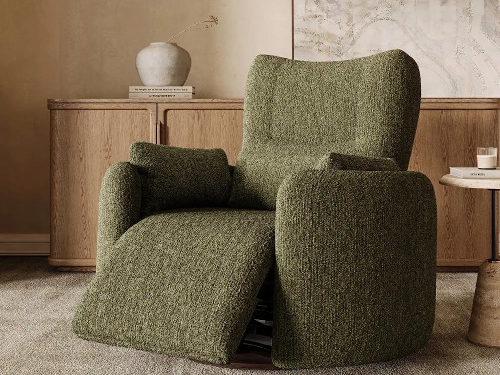 Olive green textured power recliner with an extended footrest in front of a wood sideboard and neutral wall art.