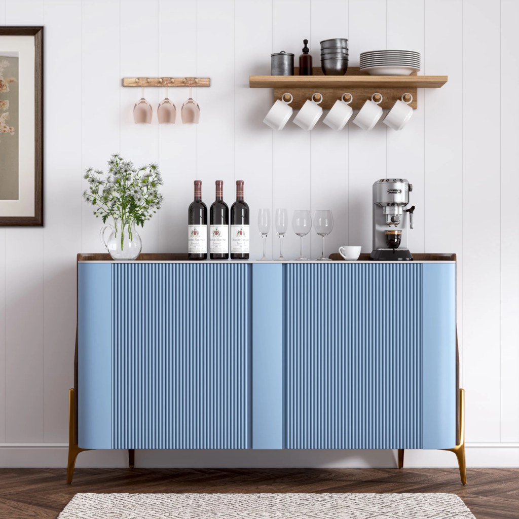 Blue sideboard with fluted cabinet doors, vertical wall paneling, open shelves, glassware, and warm wood accents in a modern dining area.