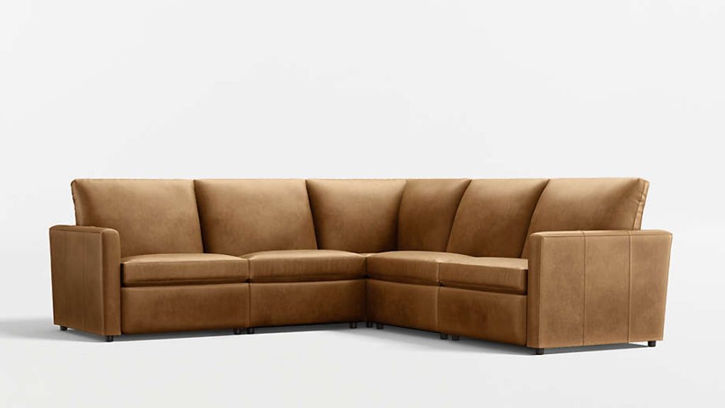 Tan leather reclining sectional sofa with wide arms and deep cushioned seats, shown against a clean white background.