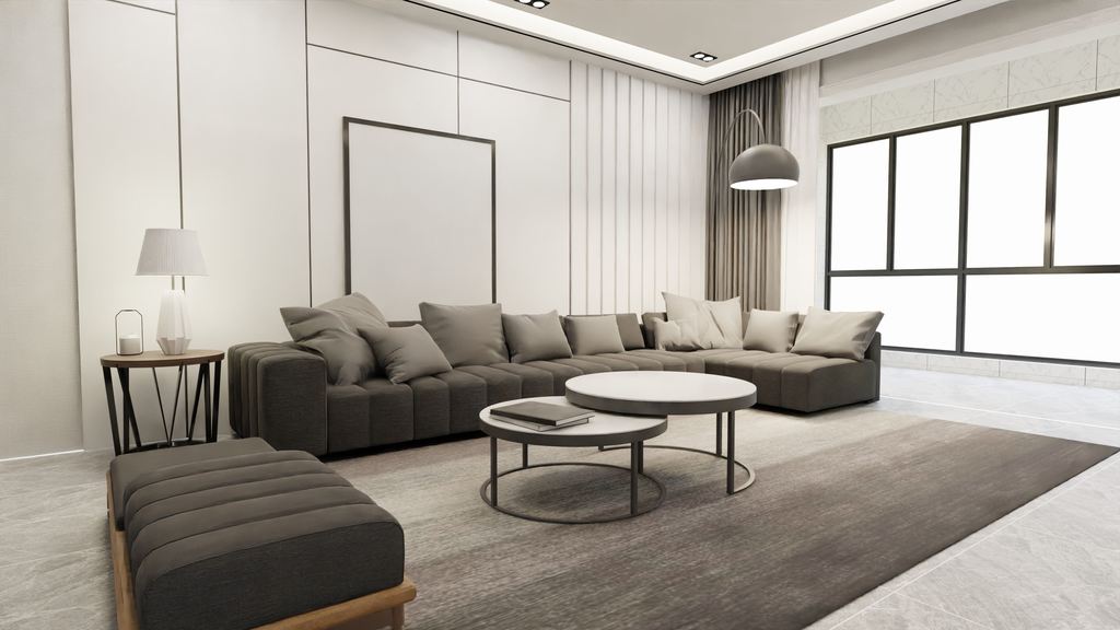Modern living room with a large gray sectional sofa, chaise lounge, round coffee tables, side table, area rug, and bright floor-to-ceiling windows.