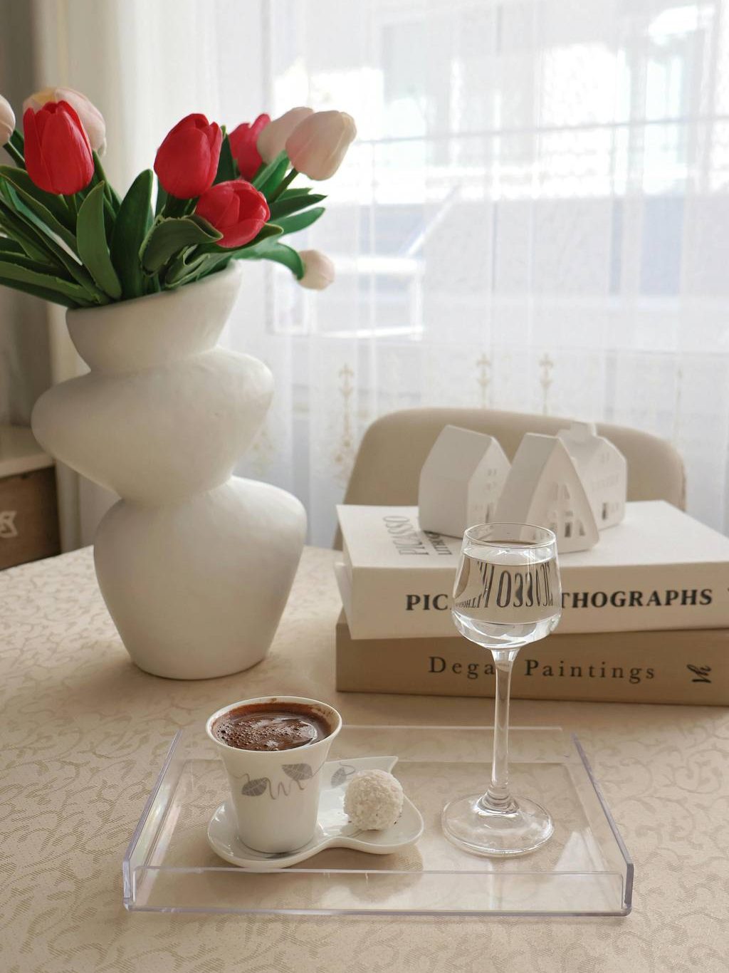 light modern minimalist tray styling with an acrylic tray, sculptural vase, books, and simple drinkware