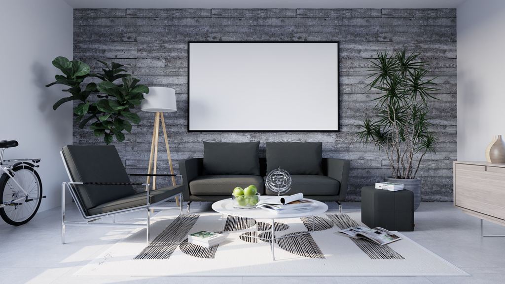 Minimalist living room with gray sofa, lounge chair, round white coffee table, indoor plants, and a textured concrete accent wall.