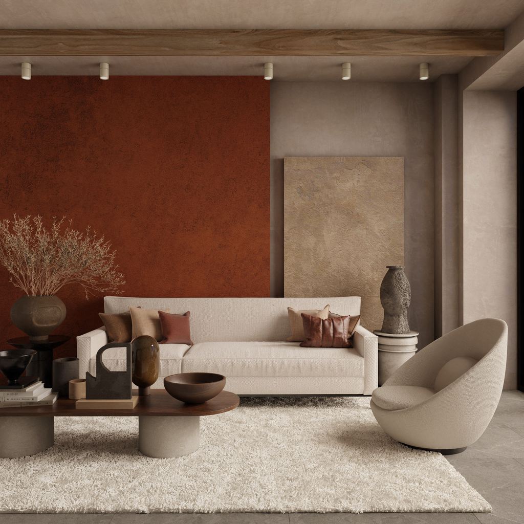 Warm minimalist living room with a cream sofa, terracotta accent wall, textured rug, wood coffee table, and curved lounge chair.
