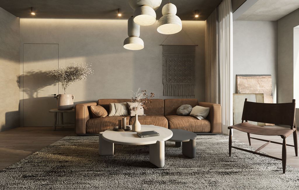 Warm modern living room with brown sofa, round coffee tables, pendant lights, lounge chair, textured rug, and asymmetrical wall decor.