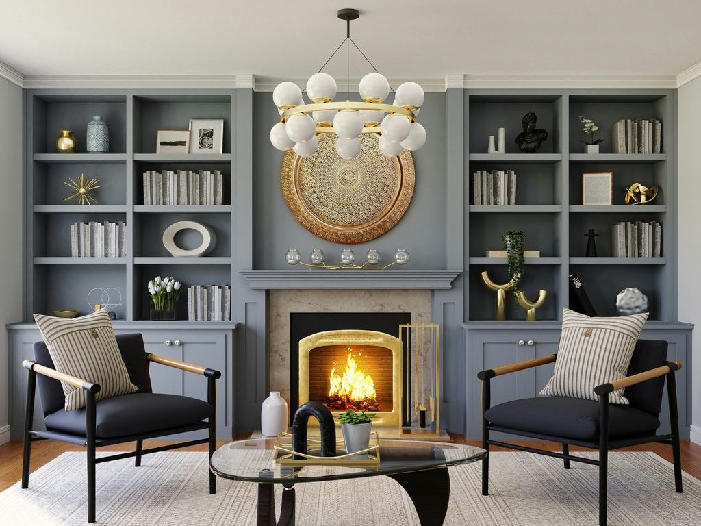 Elegant living room with a lit fireplace, gray built-in shelves, black accent chairs, glass coffee table, chandelier, and gold mantel decor.