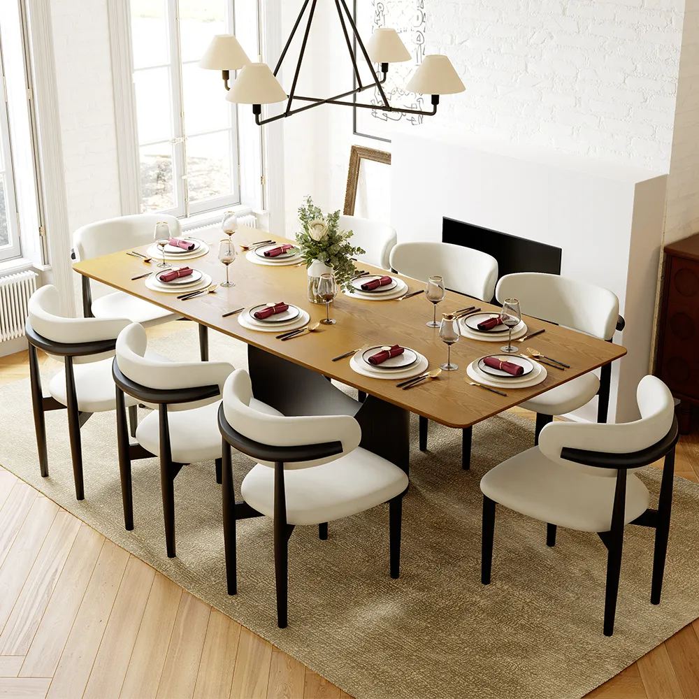 a rectangular wood dining table with metal leg and 8 dining chairs around, and some plates, knives and forks and glasses on top in a minimalist dining room