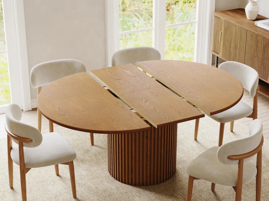 Silva-Round Extendable Dining Table with five chairs in a modern and minimalist dining room near a cabinet