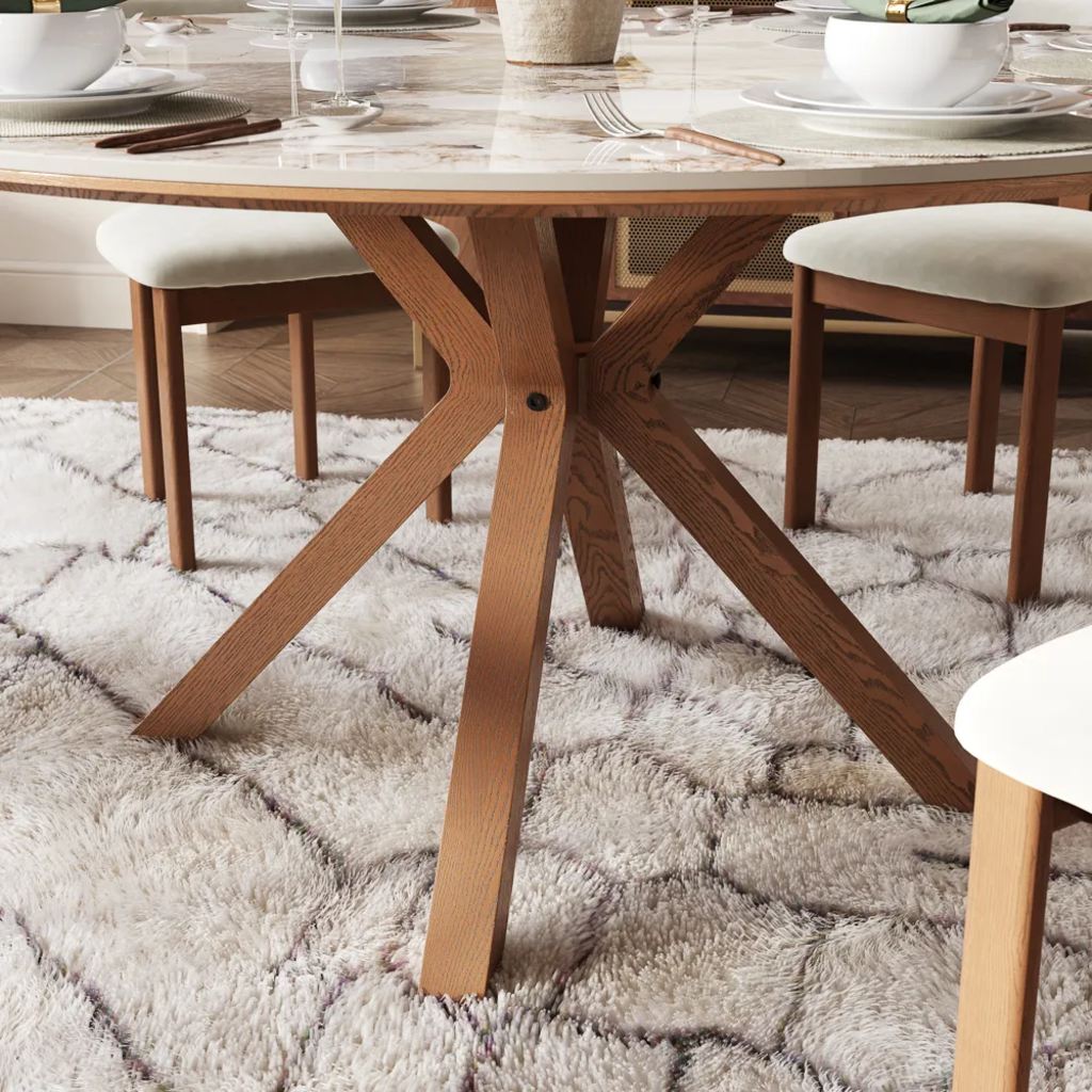a rug under the dining table and dining chair in a dining room near a console table on a wood floor