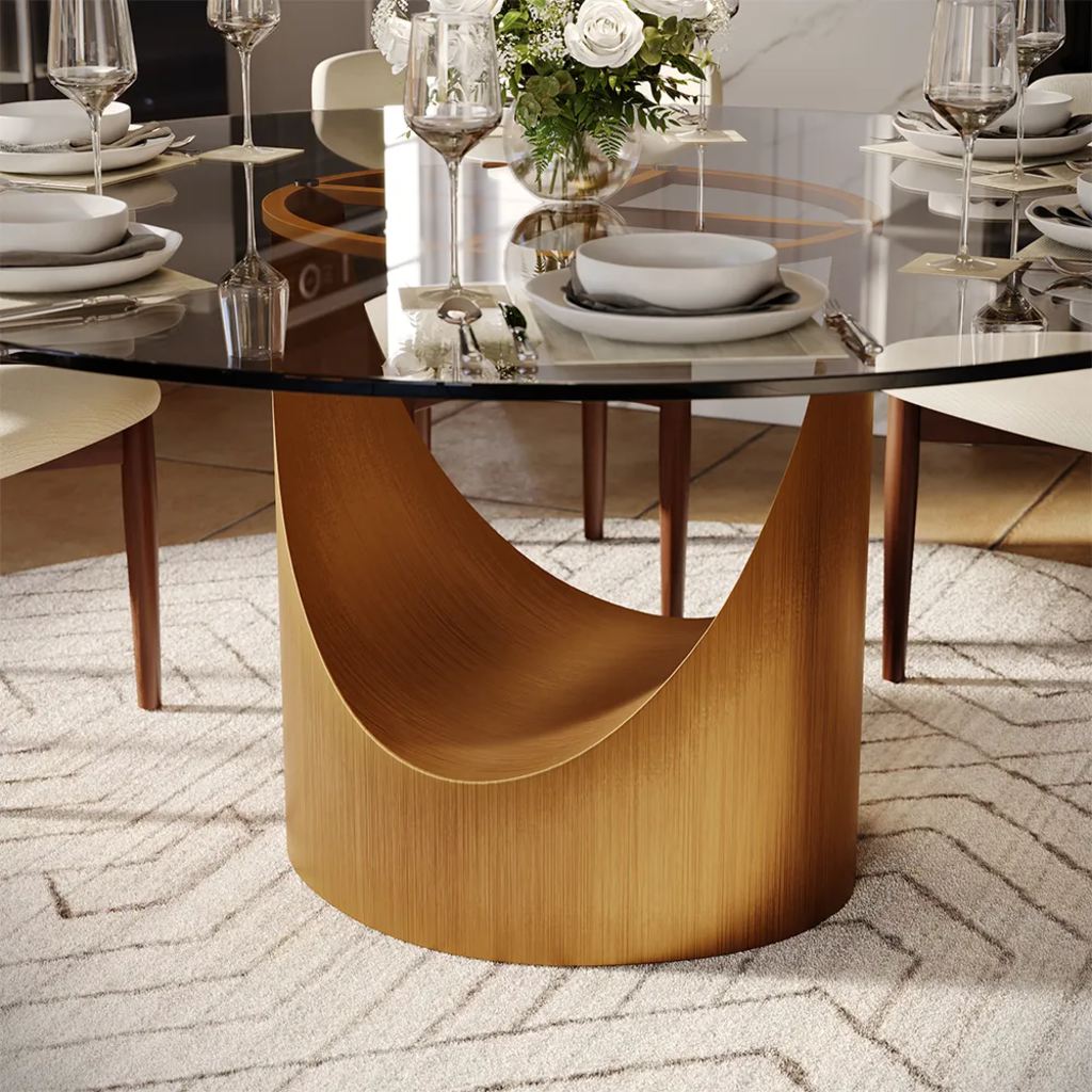 a dining table with glass top and metal legs, some plates, dishes, glass cups and a vase on top in a dining room