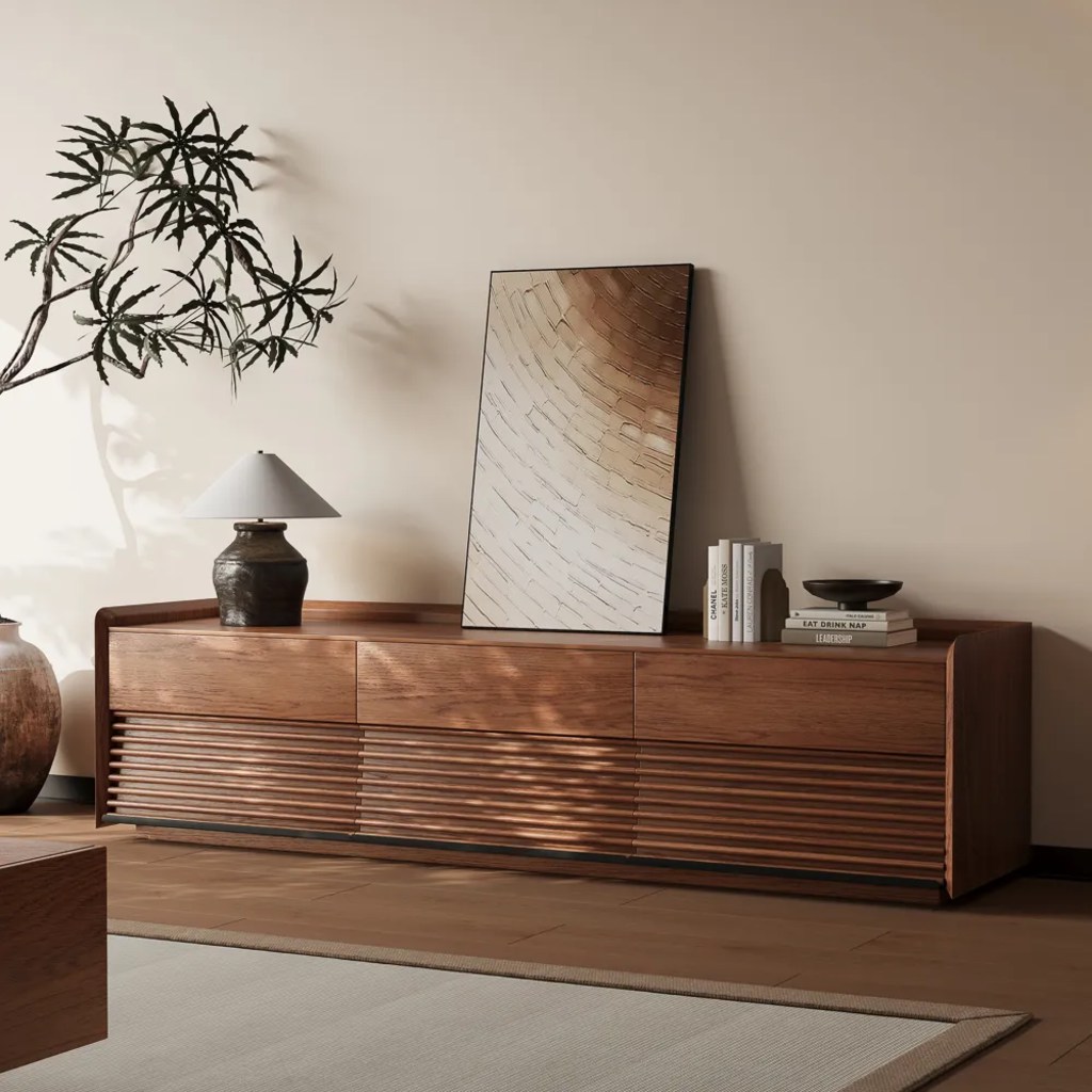 Ansel-70.87'' Mid-Century TV Stand with a lamp, a painting, some books and decorations on top near a plant in a traditional living room