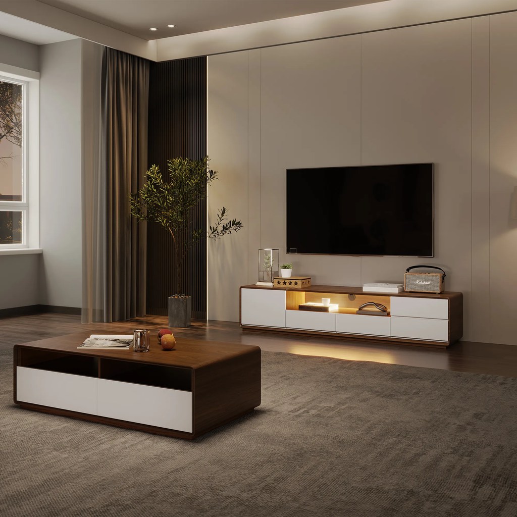 a white tv stand with decorations and consoles against a wall near a rectangular wood coffee table in a modern living room