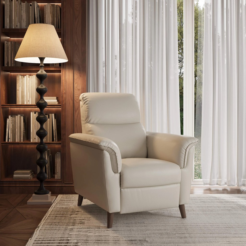 a white chair near a floor lamp and a wood bookshelf with books in a bright reading area