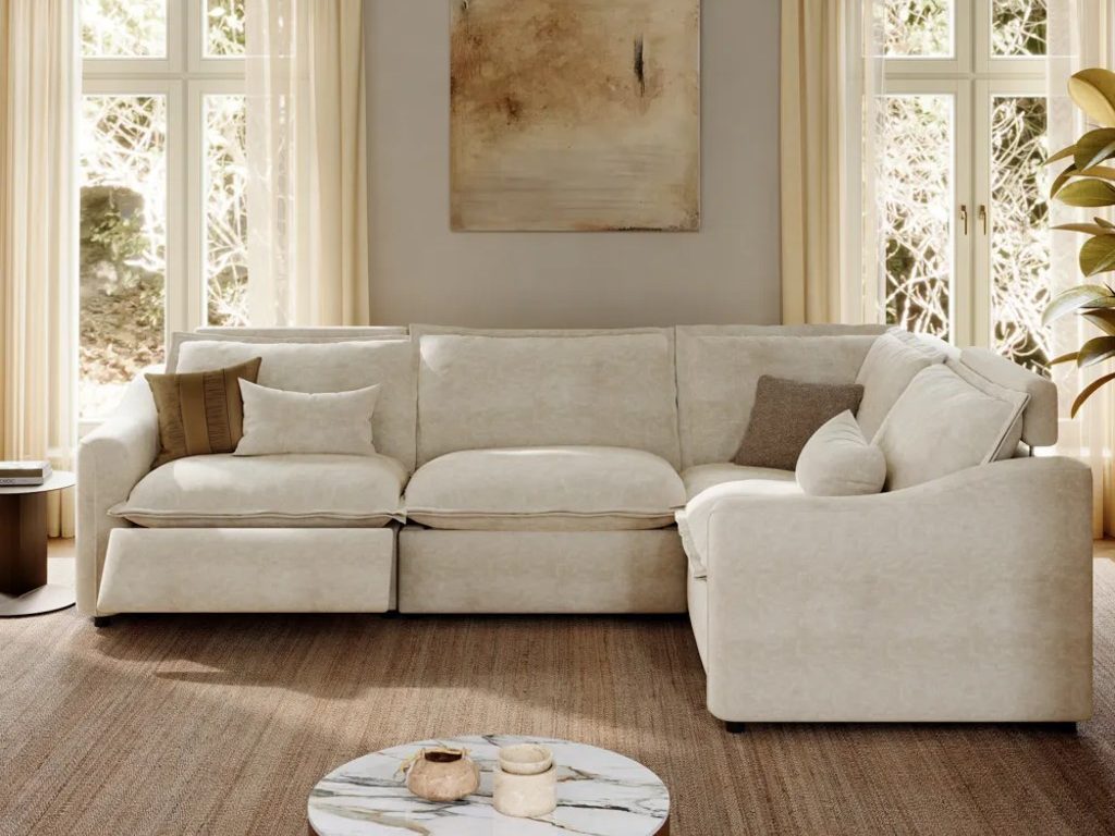 Ergopals-Power Reclining Sofa with cushions near a side table, a round coffee table with marble top and a plant in a bright and cozy living room