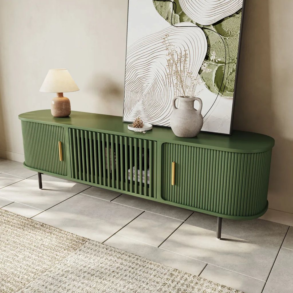 a green media console with slide doors, a lamp, a vase, a painting and some decorations on top in a minimalist and bright living room