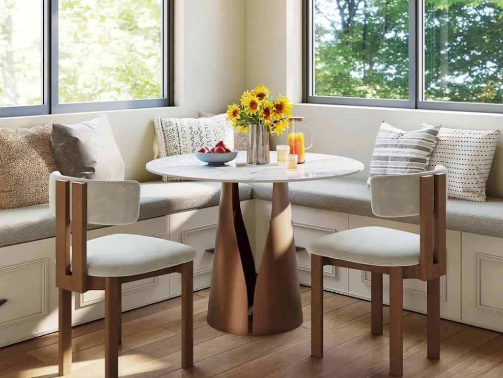 Sunny breakfast nook showcasing a neutral fabric corner bench dining set with custom storage drawers.