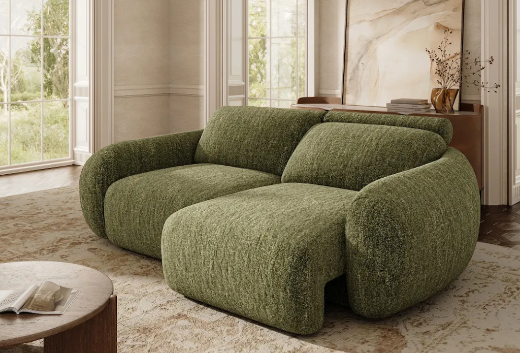 Chubby, olive green textured fabric sleeper sofa with one seat extended, styled in a warm luxury interior.